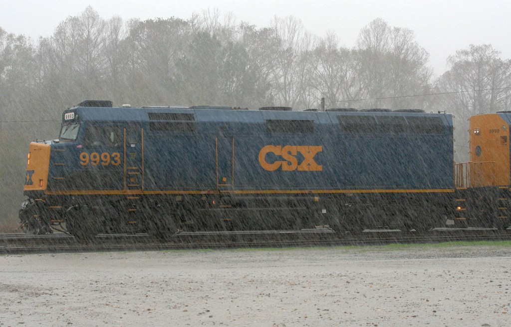 CSX Business train in pouring rain